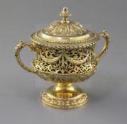 An Edwardian silver gilt two handled pedestal cup and cover by Nathan & Hayes, of campana form,