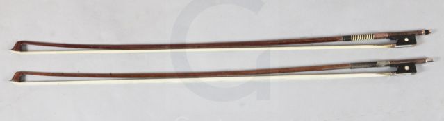 Two violin bows, one silver and the other gold mounted, unstamped, each with an octagonal stick