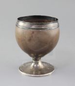 A George III silver mounted pedestal coconut cup, by Phipps & Robinson, with reeded foot, London,