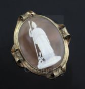 A Victorian engraved gold mounted oval cameo pendant brooch, carved with Pallas Athena and the