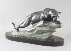 M. LeDucq. An Art Deco patinated spelter model of a panther upon a rock, signed, on oval black