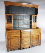 A George III oak breakfront dresser, the associated three shelf rack with two glazed doors, over