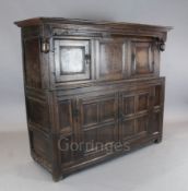 A 17th century oak court cupboard, with central panel flanked by doors over two central panelled