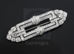 An Art Deco pierced platinum? and diamond set openwork brooch, of rectangular form with tapering