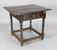 A 17th century oak centre table, with rectangular top and single drawer opening from two sides, on