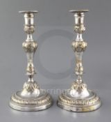 A pair of French Louis XV silver plated candlesticks, with waisted knopped stems, om circular bases,