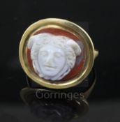 An antique gold and Roman? sardonyx cameo set oval ring, the cameo carved with the head of a man,