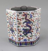 A Chinese wucai hexagonal jar, Wanli mark but later, painted with panels of phoenix and dragon, wood