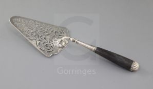 An early George III pierced silver fish slice, with ebonised handle and trowel shaped blade with