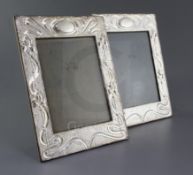 A pair of Edwardian Art Nouveau rectangular silver mounted photograph frames by Joseph & Richard
