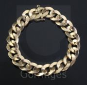 An 18ct gold flat curb link bracelet, 18.7cm, 46.3 grams.
