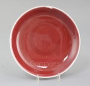 A Chinese sang de boeuf dish, Qianlong mark and probably of the period (1736-1795), the glaze on the