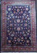 A Tabriz blue ground carpet, with field of scrolling foliage and multi row border,