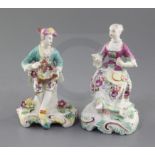 Two Derby 'Pale Family' seated figures of a gentleman and a lady, c.1756-8, holding a basket of