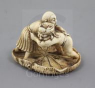 A Japanese ivory netsuke of two wrestlers, Meiji period, standing upon a curled lotus pad, unsigned,