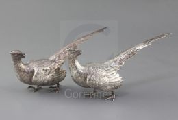 A modern matched pair of silver free-standing model pheasants, with textured feathers, AC.Co,