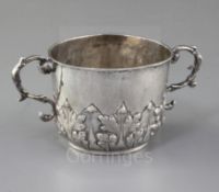 A Charles II silver porringer, with embossed foliate decoration and the initials E*B to the