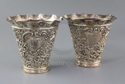 A pair of late Victorian pierced repousse silver vases by James Deakin & Sons, of flared form,