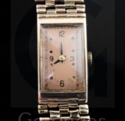 A lady's gold Moeris manual wind wrist watch on a 14k gold bracelet, the rectangular copper coloured