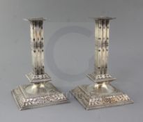 A pair of Victorian pierced silver square cluster column candlesticks by John Newton Mappin, the