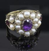 An antique gold, amethyst, garnet and pearl set cluster ring, with reeded shank, size M.