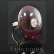 A late Victorian gold and oval cabochon garnet dress ring, with inset old cushion cut diamond, (with