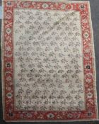 A Zeigler carpet, the ivory field with an all-over design of single floral sprigs, the madder border