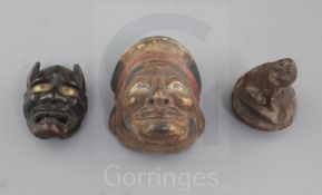 A Japanese bamboo seal in the form of a dog and two wood masks, 19th/20th century, the larger mask