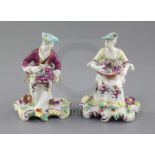 A near pair of Derby seated figures of fruit sellers, c.1759-60, each holding a basket of fruit,