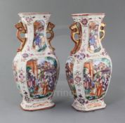 A pair of Chinese famille rose 'Mandarin' hexagonal baluster vases, Qianlong period, each painted