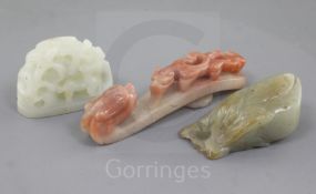 Three Chinese jade carvings, Qing dynasty, the first in pale celadon jade a hat finial carved in