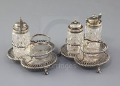 A pair of Victorian silver three division cruet stands by Edward Hutton, with engraved