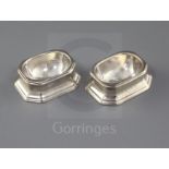 A pair of George I silver trencher salts by Arthur Dicken, with engraved monogram, (one Brittania