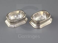 A pair of George I silver trencher salts by Arthur Dicken, with engraved monogram, (one Brittania