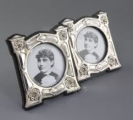 A pair of Edwardian Art Nouveau shaped silver mounted photograph frames by J. Aitken & Son, embossed