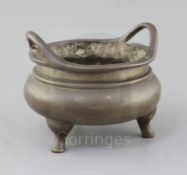 A Chinese bronze censer, Ding, Qing dynasty, with a pair of high looped handles on three cabriole