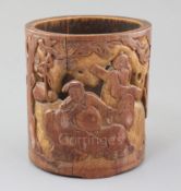 A Chinese bamboo brush pot, carved in low relief and pierced with two figures of a safe and