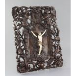 A late 18th/early 19th century Flemish walnut and ivory crucifix, carved with Christ upon a