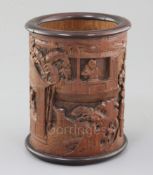 A Chinese bamboo and hongmu mounted brush pot, Qing dynasty, finely carved in high relief with