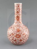 A Chinese iron red painted bottle vase, Qianlong mark but late 19th/early 20th century, painted with