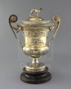A handsome George III silver gilt two handled presentation pedestal trophy cup and cover by