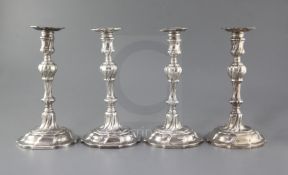 A matched set of four late 18th century silver candlesticks, engraved with the Heneage family crest,