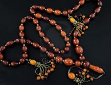 A Persian gilt metal and graduated amber bead tassel drop necklace, gross weight 198 grams, 180cm