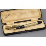 A cased Namiki 14k rolled gold fountain pen, with foliate engraved barrel stamped 'Namiki Made in