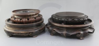 Four Chinese large hardwood stands, late 19th/early 20th century, two with petal lobed borders,