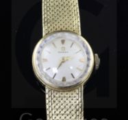 A lady's 18ct gold Omega manual wind wrist watch, on integral 18ct gold Omega bracelet.