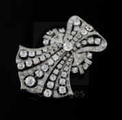 An Art Deco style diamond and platinum openwork claw, collet and pave-set fan shaped brooch, 52mm.