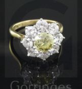 A 1960's 18ct gold and diamond cluster ring by Cropp & Farr, the central fancy yellow stone weighing