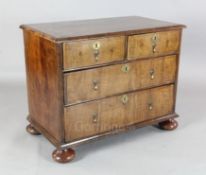 A George II walnut chest, of two short and two graduated long drawers, on bun feet, W.3ft 2in. D.1ft