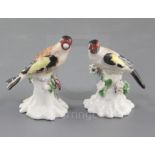 A near pair of Derby figures of goldfinches, c.1765-70, each perched on a flower encrusted tree